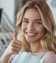 Dental patient making thumbs up gesture