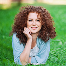 woman with curly hair smling